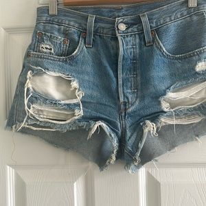 Levi’s 501 distressed denim shorts size 25.  Medium blue color with button fly.
